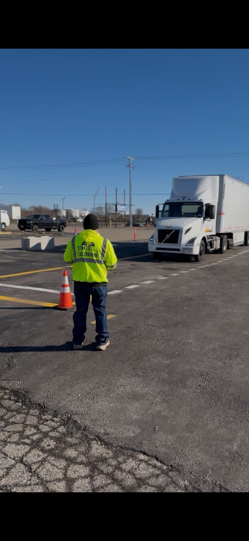 Instructor guiding student backing maneuver