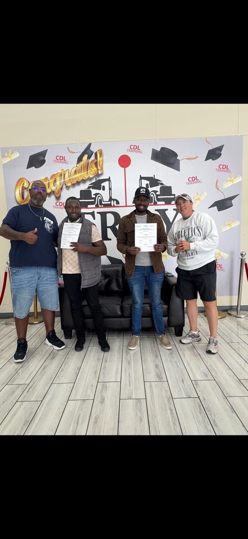 Group of graduates holding CDL certificates